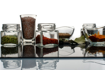 a variety of spices in glass bowls