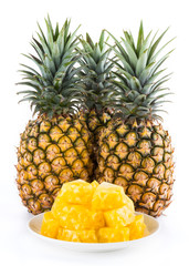 Sliced pineapple on a white plate, it is a sweet and juicy fruit.