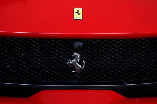 Ferrari Logo on Red Sport Car in the paddock of Mugello Circuit. Ferrari S.P.A. is an Italian luxury sports car manufacturer, founded by Enzo Ferrari.