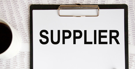 Suppliers - on the tablet inscription. There are glasses nearby. Against the background of accounting.