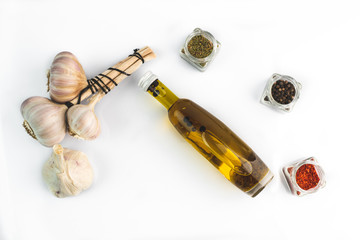 glass bottle of extra virgin oil with thyme, garlic and pepper