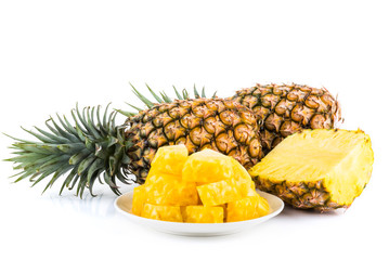 Sliced pineapple on a white plate, it is a sweet and juicy fruit.