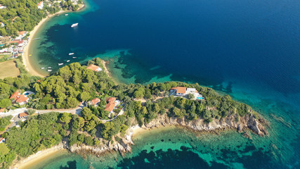 Aerial drone photo of famous seaside area and bay of Kanapitsa with many beautiful secluded sandy beaches, Skiathos island, Sporades, Greece