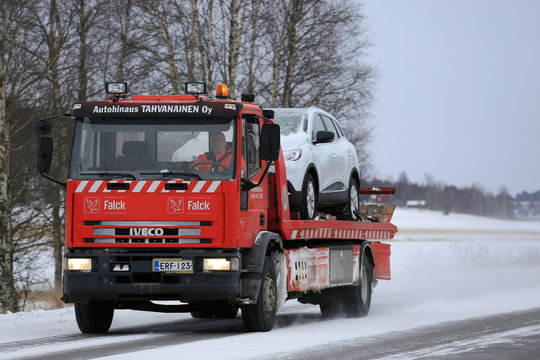 Red Tow Truck Tows a Breakdown Car in Winter. Illustrative Editorial content.