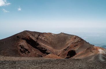 Fototapeta na wymiar Hikers and tourists walking on black sand Silvestri Craters near Mount Etna - Sicily, Italy