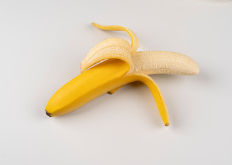 Peeled banana on white background