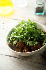 Homemade beef ragout with fresh arugula