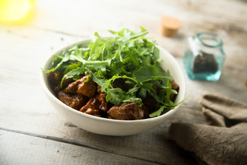 Homemade beef ragout with fresh arugula