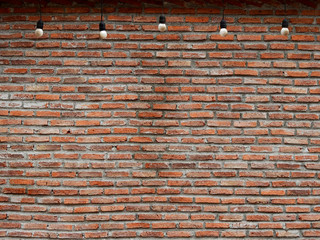 old brick wall with hanging light bulb
