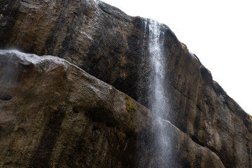 Waterfall from the cliff against the sky
