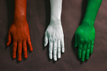 three hands are painted with three colors,saffron,white and green to represent tricolor Indian...