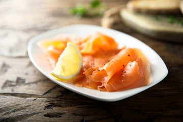 Homemade smoked salmon with lemon