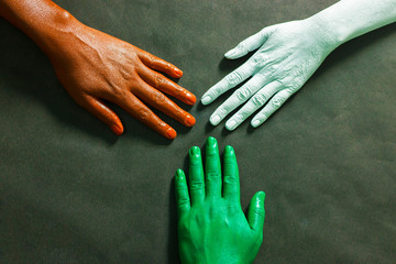 three hands are painted with three colors,saffron,white and green to represent tricolor Indian...