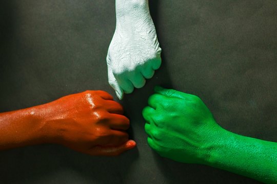 three hands are painted with three colors,saffron,white and green to represent tricolor Indian national flag.15 August Independence day India.celebration of freedom.symbol of brotherhood.   
