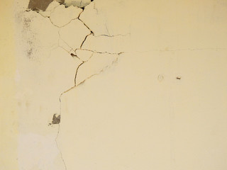 old yellow wall with crack from earthquake effect