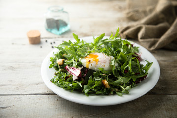 Healthy arugula salad with poached egg