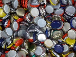 Many old, used bottle caps made of metal
