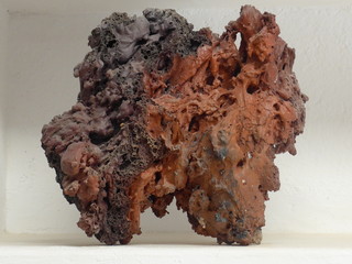 Magma. Close up of a part  of volcanic rock in front of white background. Canary Island of Lanzarote, Spain.
It looks like a piece of chocolate fudge.