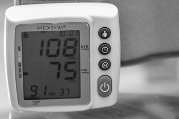 Close up, detail of blood pressure cuff monitor isolated. Digital blood pressure measuring device....