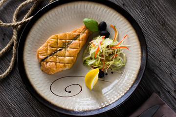 a piece of grilled fish. Red fish with cages from the grill