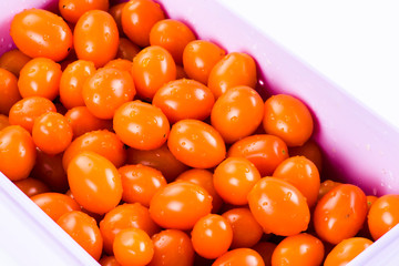 red cherry tomatoes Isolated In a transparent plastic box