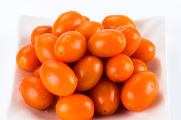 Close-up of fresh cherry tomatoes on a white dish