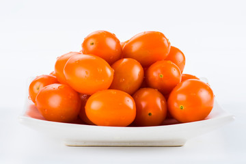 Close-up of fresh cherry tomatoes on white background