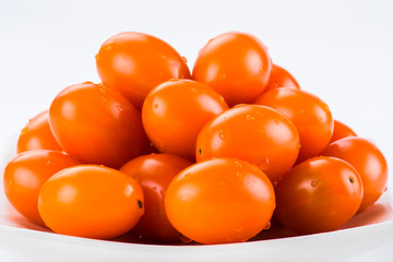 Fototapeta na wymiar Close-up of fresh cherry tomatoes on a white dish