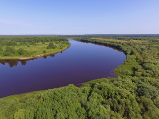 Fototapeta na wymiar Bend of the Vychegda river against the blue sky, Komi Republic, Russia.