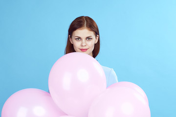 Fototapeta na wymiar Beautiful woman with pink balloons holiday fun birthday Gift happiness blue background