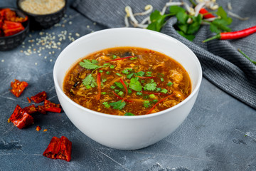 spicy sour soup Chinese cuisine on grey table