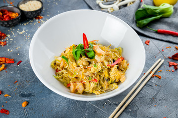 wok with shrimp on grey table