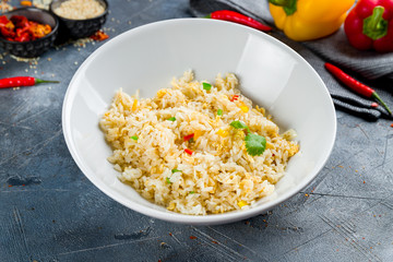 Rice with vegetables on grey table