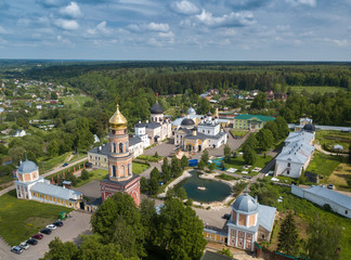 Fototapeta na wymiar Aerial summer view of white old monastery with golden domes in Russia.