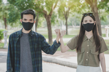 Asian women man a wearing face mask hello shake hand new normal social distancing,No touching