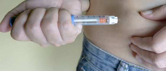 Diabetic patient makes an insulin injection. Treatment and control diabetes concept