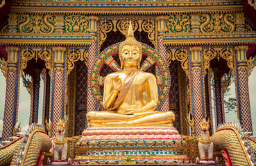 
A Buddha image in Buddhism stands in front of Wat Huay Yai Church, Chonburi, Thailand