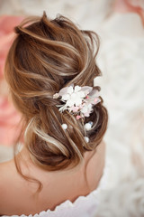 Obraz na płótnie Canvas Closeup of Bridal wedding hairstyle with jewelry wreath. Back view. Elegant bride with Wavy hair.