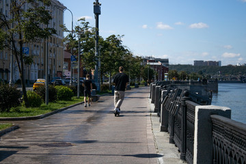 Obraz premium Moscow, Russia-August 8, 2020: people ride scooters along the embankment alley