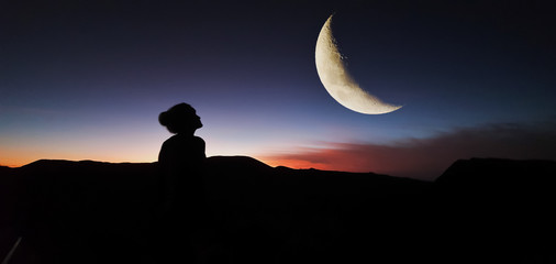 silhouette of a woman with the moon