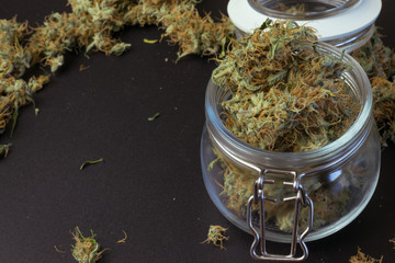 Medical cannabis jar with copy space background with marijuana. THC legal drug use in healthcare. Weed industry