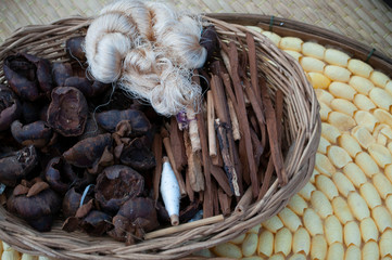 Silk thread from a dyed pupa.Silk thread from pupa.Traditional methods of collecting silk threads from chrysalis in Thailand