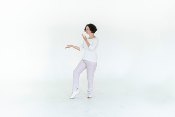 woman practicing qi qong at white studio traditional chinese gymnastics	