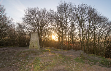 Sunrise above a hilltop trig point