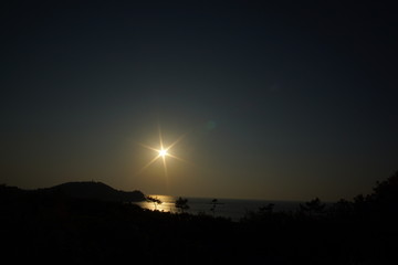 Naklejka na ściany i meble Beautiful bay view from the cliff over the setting sun 