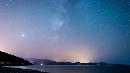 milky way over mountains and sea 