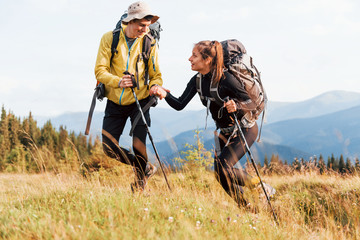 In adventure together. Cute couple. Majestic Carpathian Mountains. Beautiful landscape of untouched nature