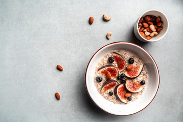 Oatmeal with figs, blueberries and nuts. Fall food concept. banner, catering menu recipe place for...