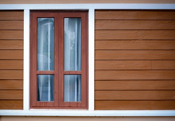window on wooden wall