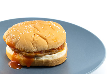 Pork burger with bacon and cheese on a white background